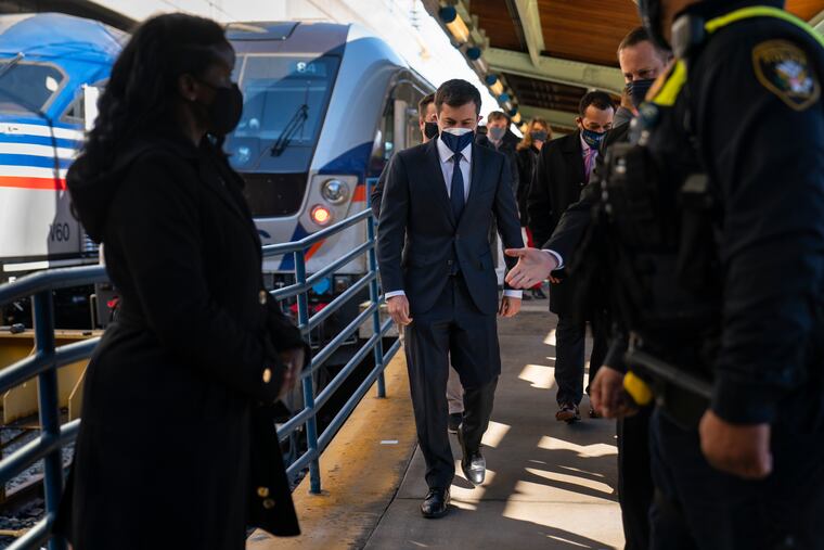Transportation Secretary Pete Buttigieg walks from a train platform after visiting with Amtrak workers at Union Station in Washington on Friday.