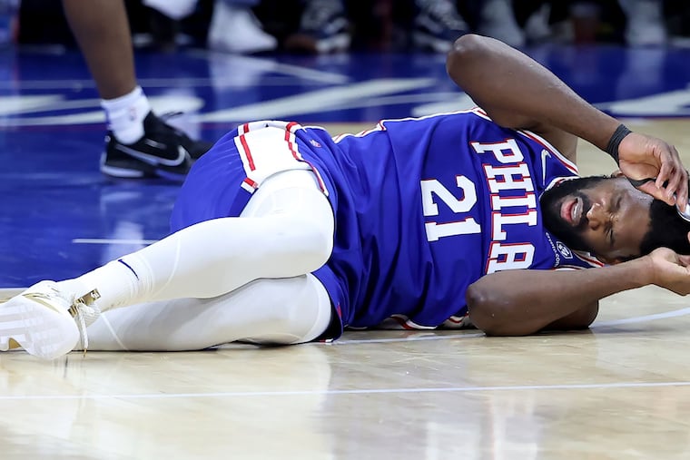 The Philadelphia 76ers' Joel Embiid on the court after a hard foul by the Miami Heat's Bam Adebayo during the second half of Game 3 in the second-round Eastern Conference playoff series at the Wells Fargo Center on May 6, 2022, in Philadelphia. (Charles Fox/The Philadelphia Inquirer/TNS)