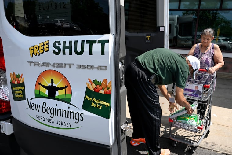 Van driver Lonnie Watkins helps Camden resident Agripina Vega unload her cart after shopping at the ShopRite in Cherry Hill Tuesday, Aug. 4, 2026. Camden is a food desert and doesn't have any grocery stores. Pastor Amir Khan is on a mission to help residents eat healthier. With a grant from FEED NJ, Khan is picking up residents and transporting them free of a charge to the suburban store.