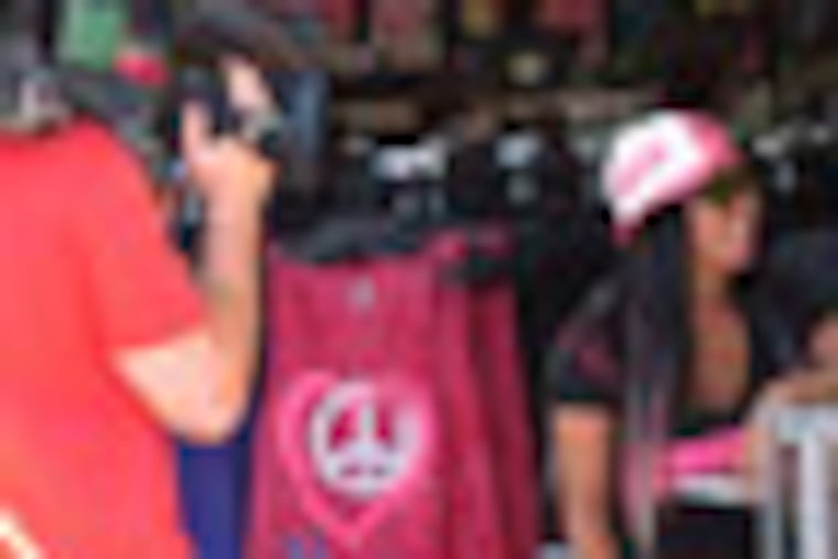 In this July 15, 2011 photo, MTV cameras film Nicole "Snooki" Polizzi during the taping of a "Jersey Shore" episode on the Seaside Heights, N.J., boardwalk. A New Jersey assemblyman introduced a law on Monday, Sept. 24, 2012, that would let towns regulate the filming of reality TV shows within their borders, including charging for the cost of extra police protection. (AP Photo/Wayne Parry)