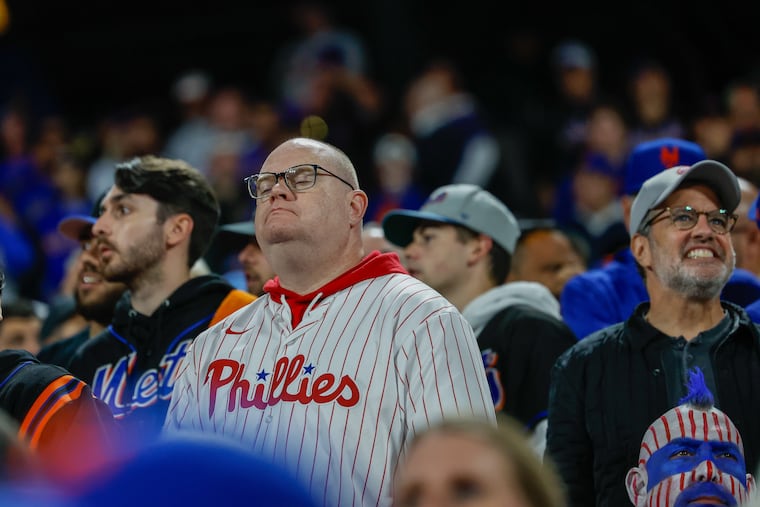 A Phillies fan at Citi Field during the team's 7-2 loss to the New York Mets in Game 3 of the National League Division Series on Tuesday in New York. The Phils lost again to the Mets on Wednesday, ending their season.