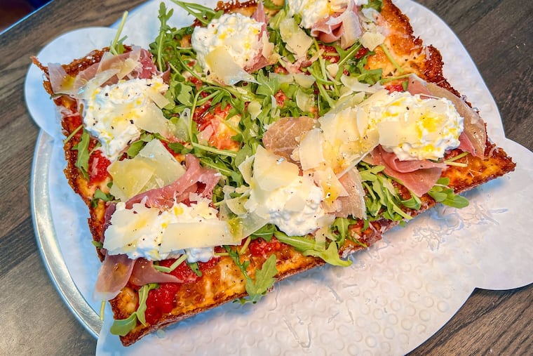 A Detroit-style Italiano, with tomato sauce, mozzarella, arugula, prosciutto, burrata, shaved parmesan, and cracked black pepper, at Mezzaluna KSQ in Kennett Square.