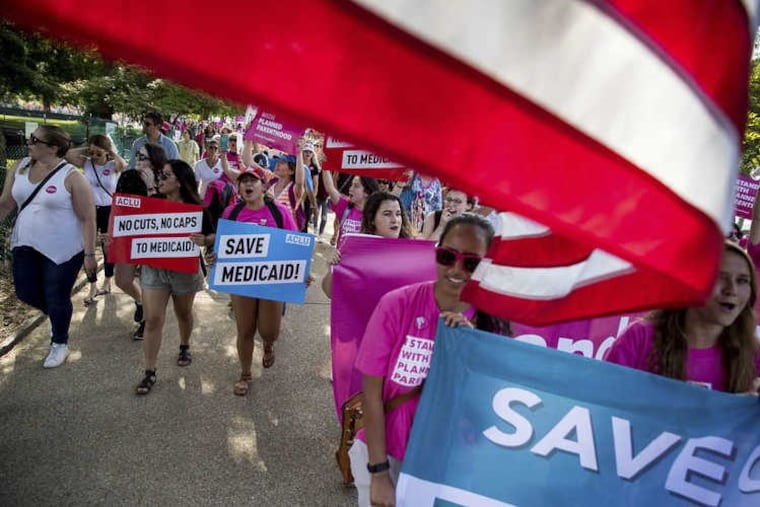 Protesters march around the Capitol Building against the Senate GOP healthcare bill in Washington Wednesday.
