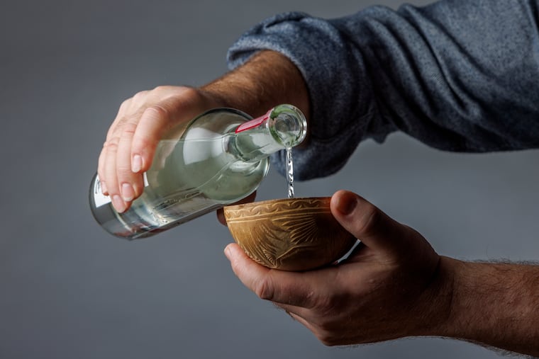 Tequila being poured into a traditional gourd vessel. Photo taken in studio, Thursday, Dec. 7, 2023.