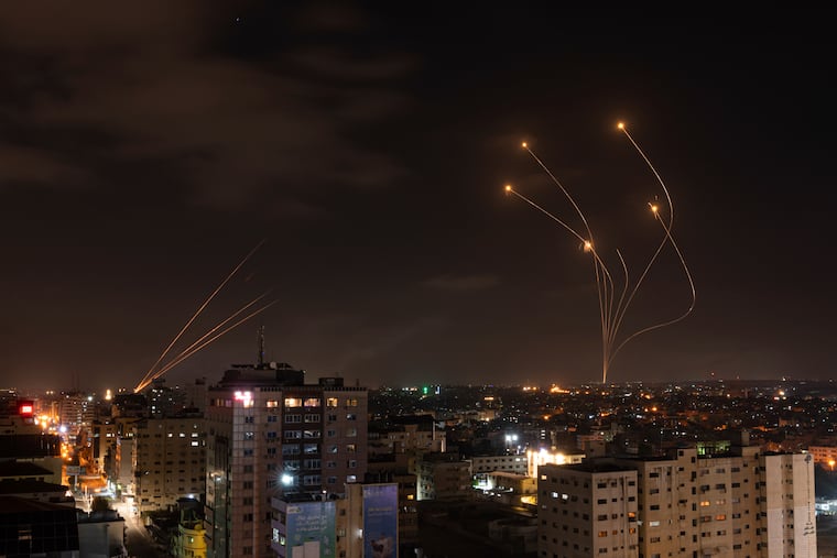 ockets fired from Gaza and intercepted by Israel's Iron Dome anti-missile system over Israeli skies are seen from Gaza City in 2023.