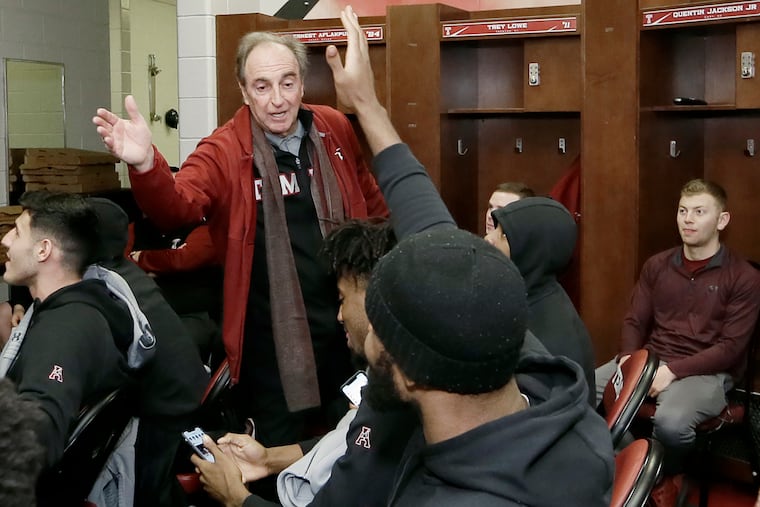 Temple head coach Fran Dunphy high fives members of the basketball team shortly after learning they were being included in the NCAA tournament. The Owls open in Dayton as underdogs.