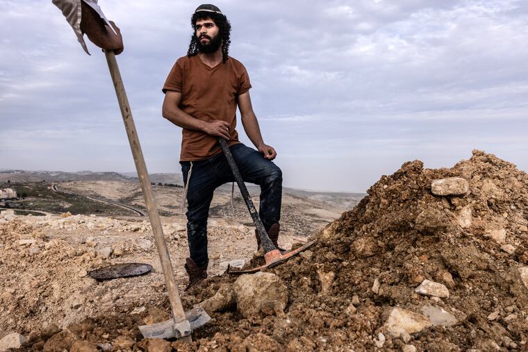 Avatar Yankovitch, a Jewish settler, clears land for new homes near the West Bank settlement of Almon last month.
