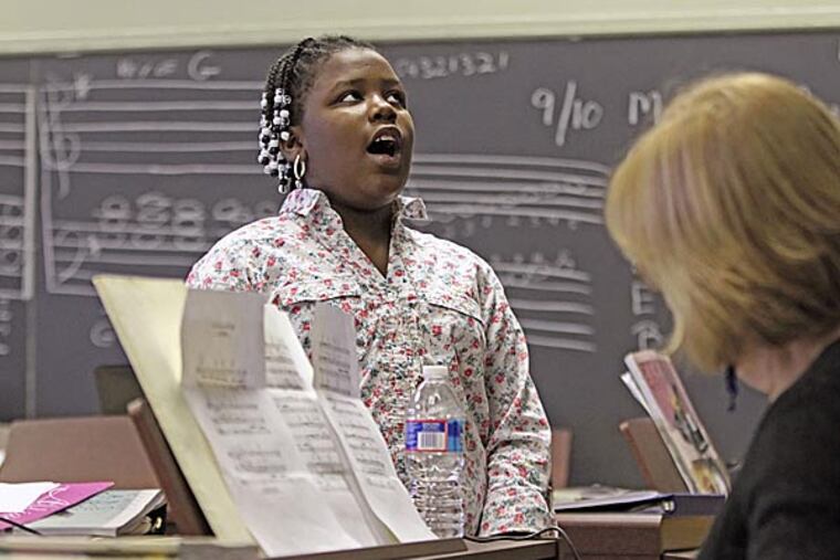 Javonah Brown, 10, left, sings "Castle in a Cloud" from Le Miserables for her vocla audition for Kathy Flaherty. (Michael Bryant / Staff Photographer)