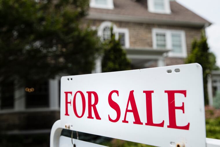 A "for sale" sign stands in front of a house in Pennsylvania, near Philadelphia, on June 8, 2018.