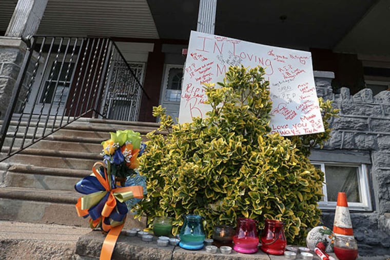 A memorial is set in front of the house on Christian Street where a man allegedly killed his brother. STEVEN M. FALK / STAFF PHOTOGRAPHER