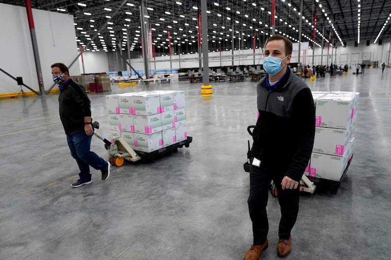 Boxes containing the Moderna COVID-19 vaccine are moved to the loading dock for shipping at the McKesson distribution center in Olive Branch, Miss., Sunday, Dec. 20, 2020.