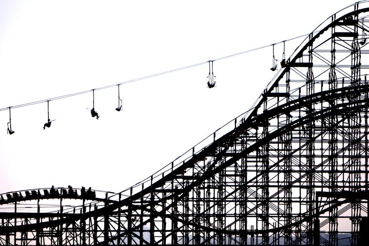 Visitors to Morey's Adventure Pier in Wildwood, New Jersey ride the "Great White" roller coaster and the "Sky Ride" chair lift on July 2, 2008.