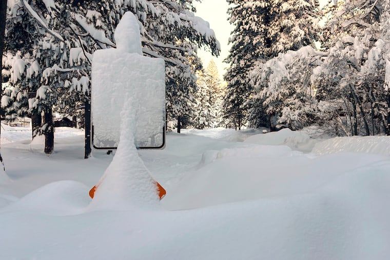 Snow covers a street sign in Truckee, Calif., on Wednesday, Feb. 18.