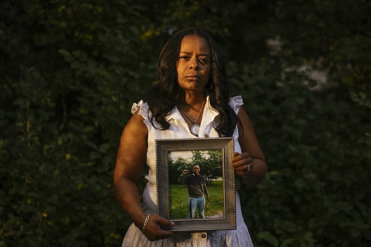 Rafiah Maxie holds a photo of her son, Jamal Clay, who died by suicide in May 2020.