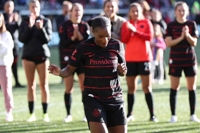 Crystal Dunn celebrates with teammates after Portland's win over San Diego.