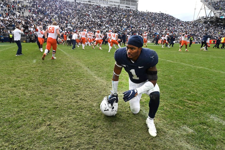 Penn State safety Jaquan Brisker reacts as Illinois players celebrate their 20-18 victory in the ninth overtime Saturday.