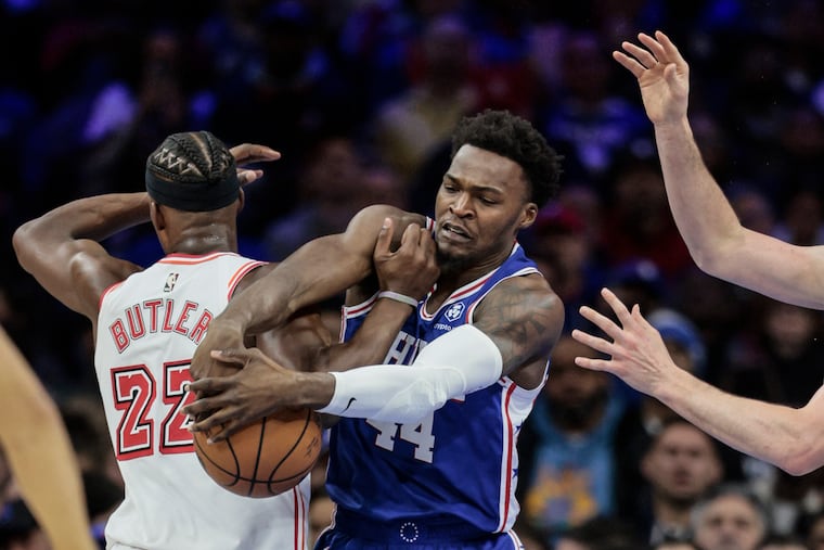 Sixers Paul Reed and the Heat’s Jimmy Butler try for the loose ball during the 3rd quarter at the Wells Fargo Center in February.