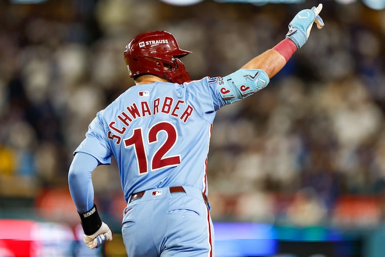 The Phillies’ Kyle Schwarber celebrates a two-run homer, his second of the night, during the eighth inning of Game 3 of the NLDS on Wednesday in Los Angeles.
