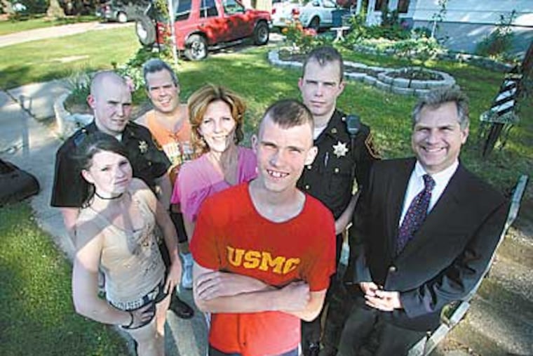 New Marine recruit Kelley Welsh is surrounded by his family and Kenneth Hartman (right). (Clockwise from left) Sister Kasey, 15, Joey,27, Joe, 50, Donna, 47, Bill, 25. ( David Swanson / Staff Photographer)