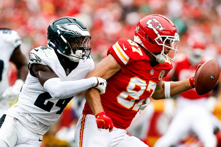 Eagles safety Drew Mukuba tries to wrap up Chiefs tight end Travis Kelce during the second quarter Sunday.