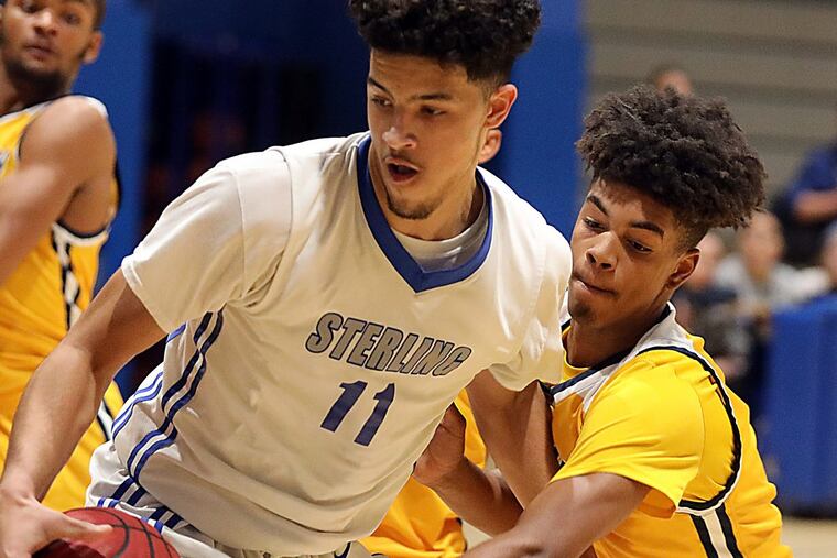 Sterling’s Noah Syer and Woodbury’s Aaron Estrada battle for the ball.