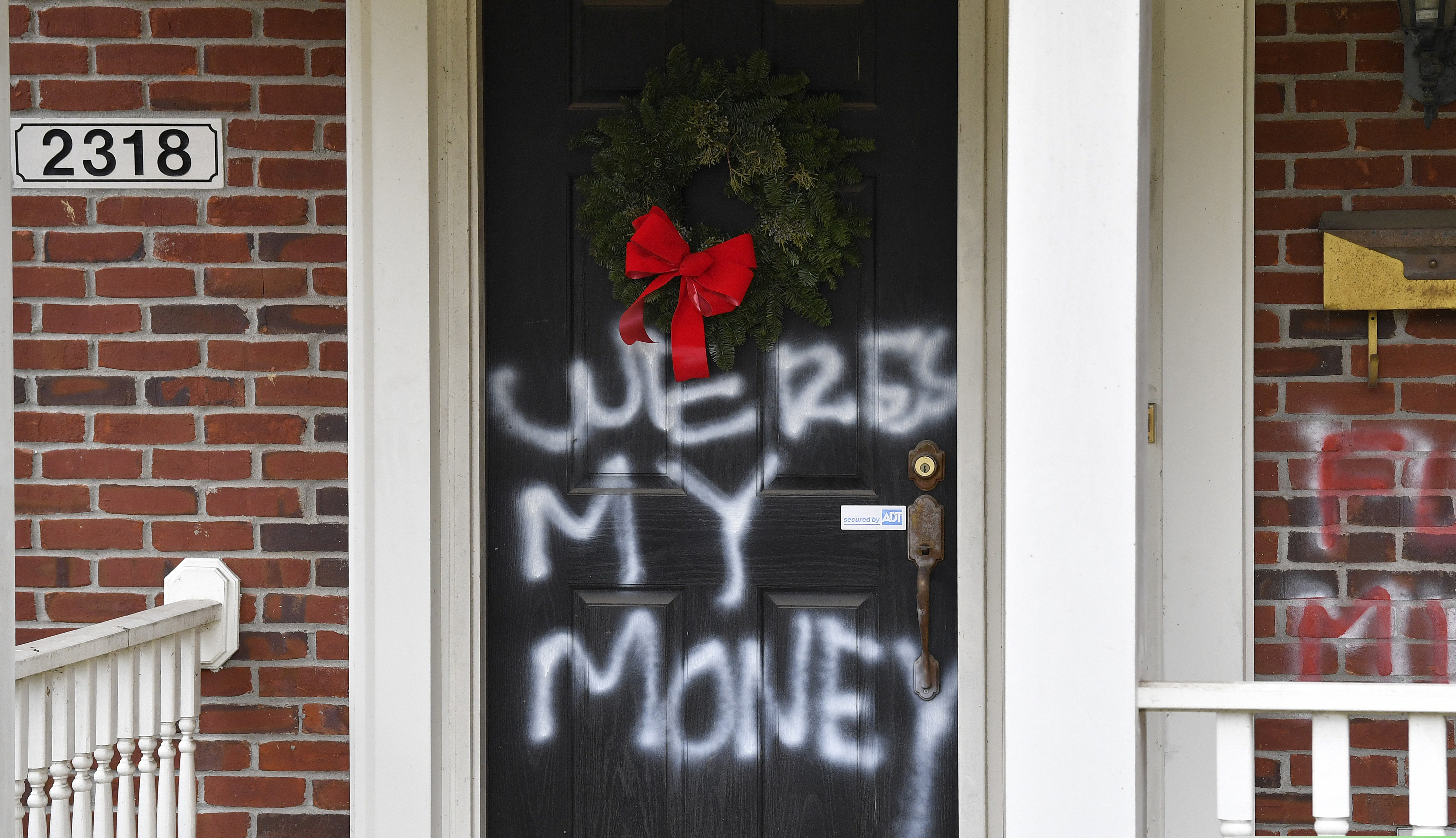 Graffiti reading, "Where's my money" is seen on a door of the home of Senate Majority Leader Mitch McConnell, R-Ky., in Louisville, Ky., on Saturday.