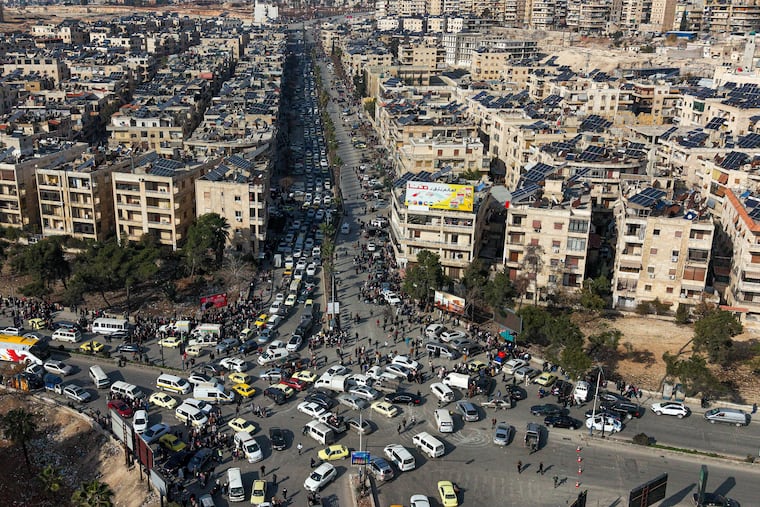 An aerial view shows Syrian residents fleeing after clashes broke out between Syrian government forces and Kurdish fighters in the northern city of Aleppo.