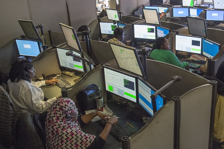 Operators in the city's 911 call center, located in the police administration building (aka The Roundhouse), take calls in November 2015. The Kenney Administration did not allow the renovated call center to be photographed. CLEM MURRAY / FILE