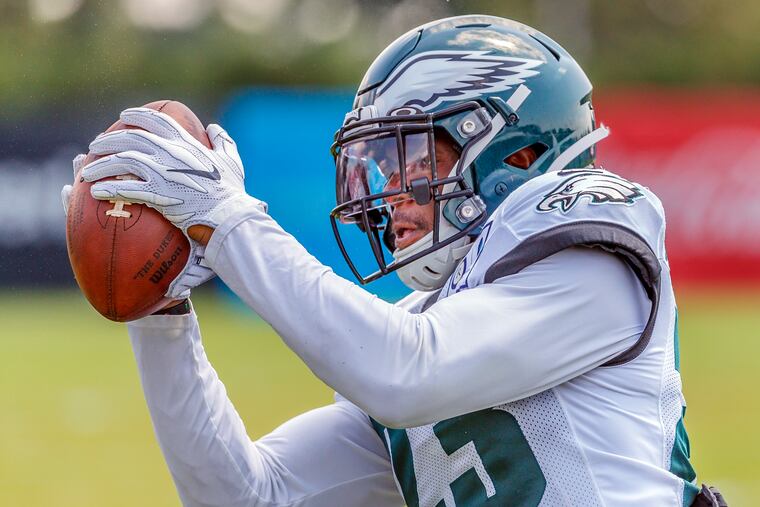 Eagles safety Rodney McLeod working on his receiving skills as he catches passes after training camp Monday.