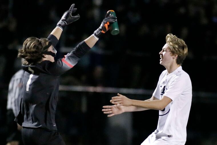 Central Bucks East goalkeeper Austin Prime (left), with teammate Will Eisold after the District 1 title win, registered 26 shutouts. ELIZABETH ROBERTSON / Staff Photographer