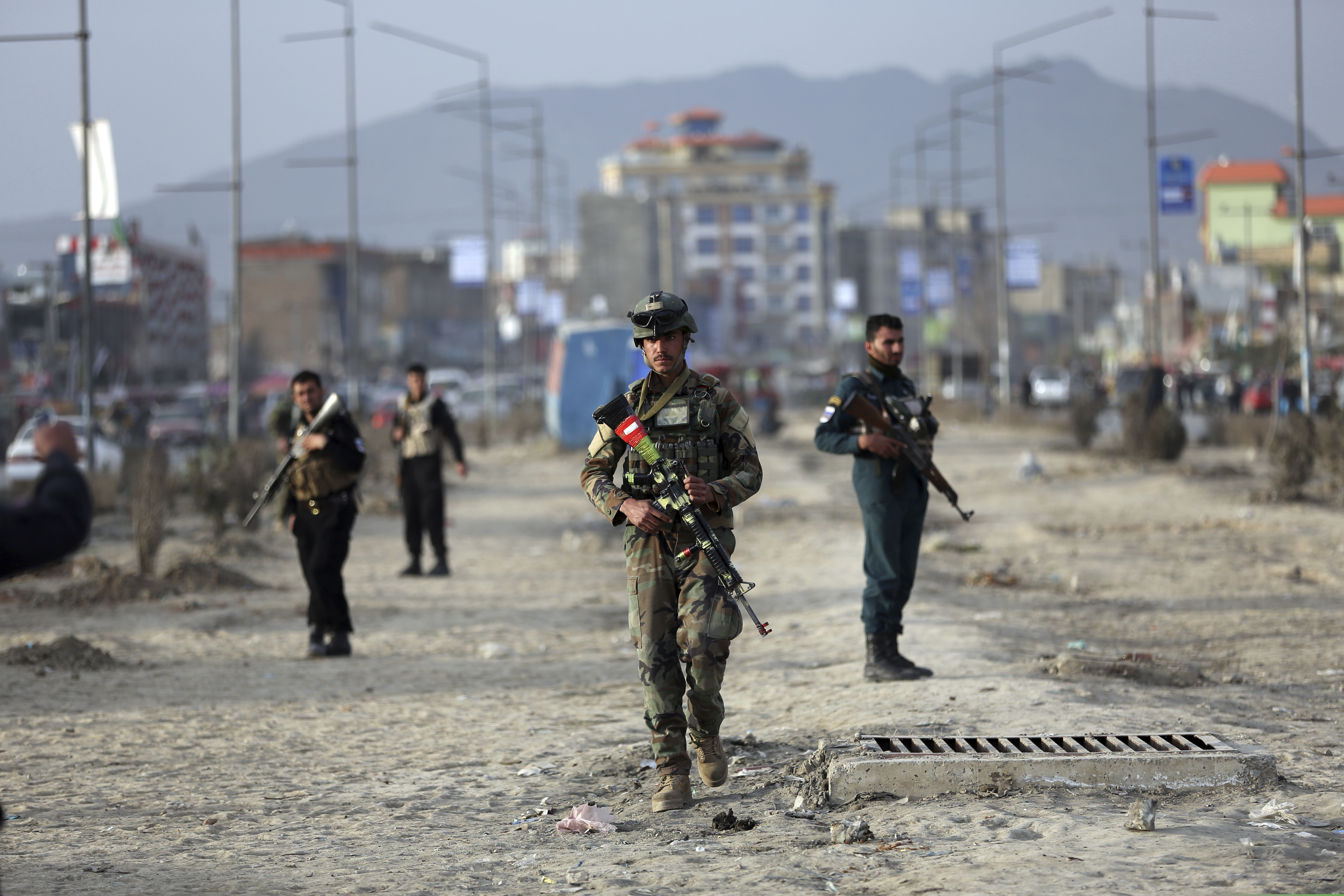 Afghan security personnel gather at the site of bomb explosion in Kabul, Afghanistan, Wednesday, Feb. 26, 2020. Afghan officials says the bomb placed in a motorbike wounded nine people. The truce between the U.S. and Taliban started last Friday, setting the stage for the two sides to sign a peace deal next week aimed at ending 18 years of war in Afghanistan and bringing U.S. troops home.
