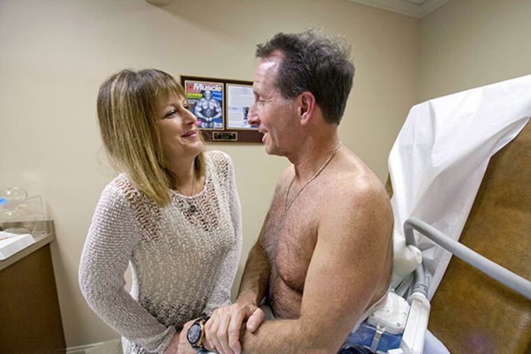 Don Chalpin is still undergoing his procedure when his wife Millie comes in to show the results of her facial procedure by Dr. Steven L. Davis at his office in Cherry Hill on January 22, 2014. ( DAVID M WARREN / Staff Photographer )