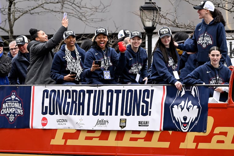 Members of the UConn women's basketball team celebrate from a bus during a parade celebrating the Huskies' NCAA women's college basketball championship in April.