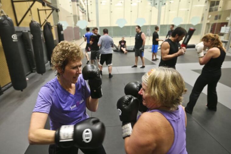 Julie Bruce, left, spars with Diane Crist during a Mixed Martial Arts based workout class called "Fight Shape" in Chanhassen, Minn., on Nov. 11, 2013. (Renee Jones Schneider/Minneapolis Star Tribune/MCT)