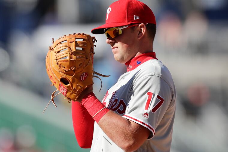 Phillies first baseman Rhys Hoskins looks at his glove after committing a catching error that resulted in a run for the Washington Nationals during the eighth-inning on Wednesday, April 3, 2019 in Washington D.C.