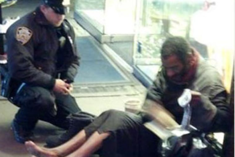 Arizona tourist Jennifer Foster took a photo of New York City Police Officer Larry DePrimo giving a homeless man boots in Times Square.