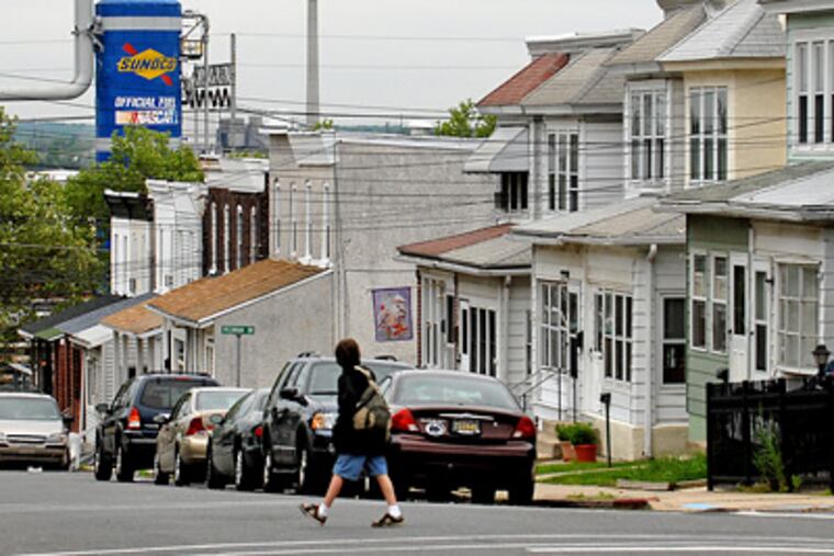 A student walks to Linwood Elementary school next to the Sunoco Marcus Hook refinery. (Tom Gralish / Staff Photographer)