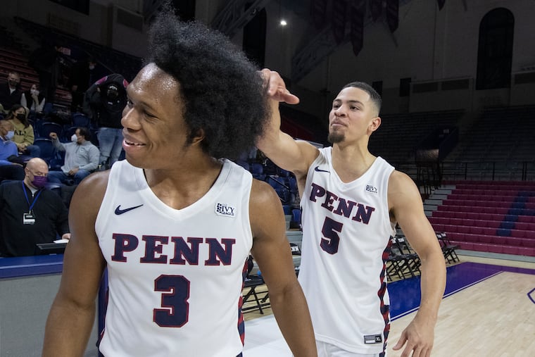 Penn's Jordan Dingle (left), pictured with teammate Jelani Williams after they beat Yale on Jan. 22, scored 31 points in Friday's win over Harvard.
of Penn gets a playful flick to his afro by teammate Jelani Williams after Dingle and his 31 point led Penn to a 76-68 victory over Yale at The Palestra on Jan. 22, 2022. Dingle usually wear his hair in corn rows.