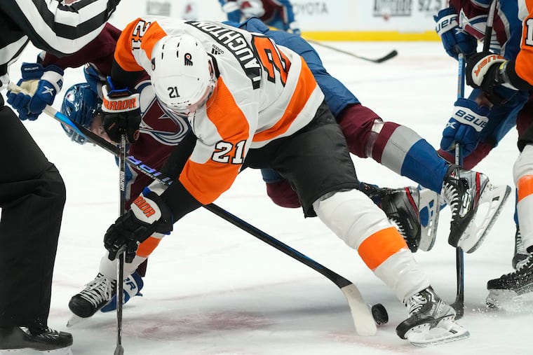 Flyers center Scott Laughton fights for control of the puck with Colorado Avalanche left wing J.T. Compher in the first period.