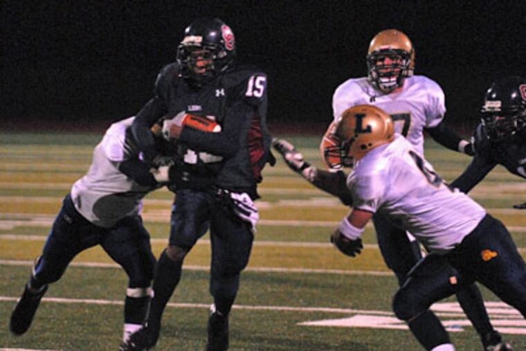 Cardinal O'Hara's Corey Brown (15) runs against La Salle last November. He is a big part of the fourth-ranked Lions' fast start: O'Hara has scored 89 points in three games. (Curt Hudson / Inquirer)