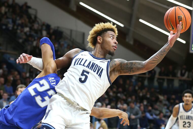 Justin Moore, right, of Villanova wins a scramble for a loose ball with Trey Alexander of Creighton during the 2nd half on Jan. 5, 2022 at the Finneran Pavilion at Villanova University.