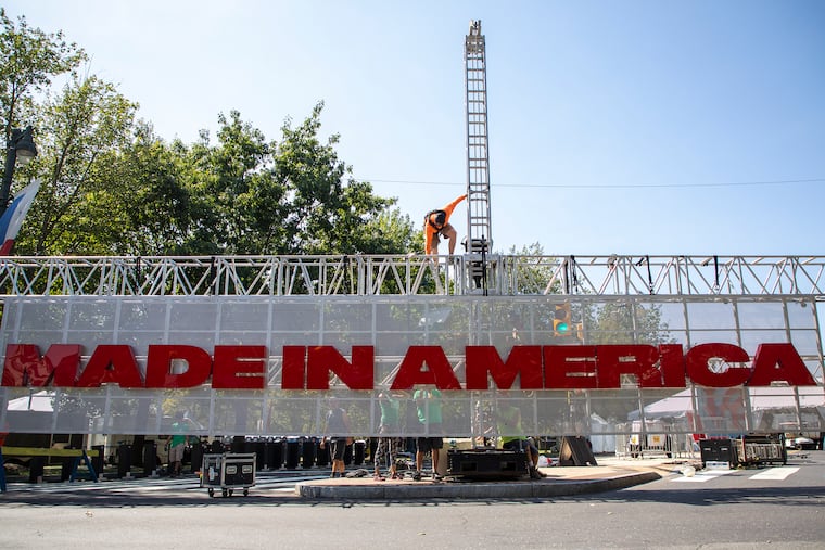 Construction workers put together the Made In America sign to be raised up before tomorrow's event this weekend on Friday, August 30, 2019.