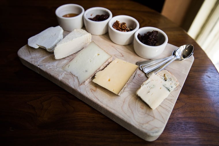 A finished cheese board sits on a table at Tria.