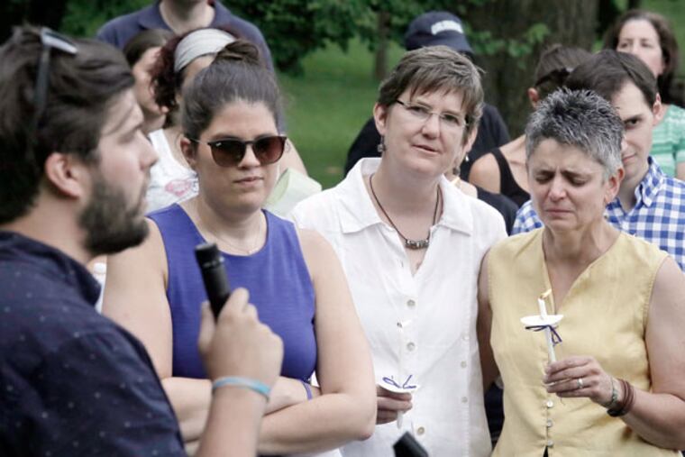 Waldron Mercy Academy alumnus Charlie Gallagher sings 'Beautiful City' from 'Godspell' while Winters (middle, white shirt) and her spouse Andrea Vettori look on during a gathering in Merion last Sunday. (ELIZABETH ROBERTSON / STAFF PHOTOGRAPHER)