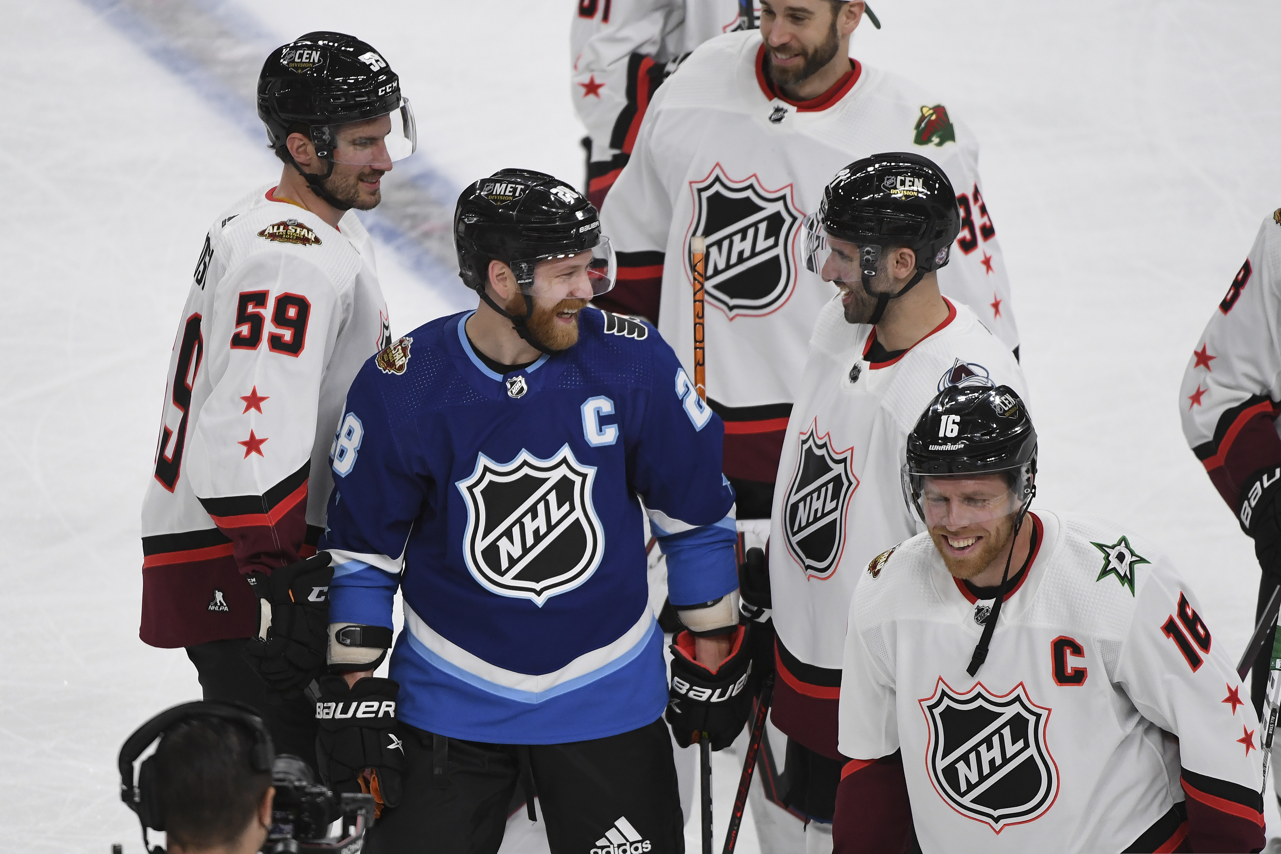 Metropolitan Division's Claude Giroux, of the Philadelphia Flyers, middle, smiles after the Metropolitan Division defeated the Central Division in the NHL All-Star hockey game final Saturday, Feb. 5, 2022, in Las Vegas.