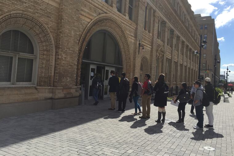 Drexel students line up to get their IDs scanned prior to entering a university building.