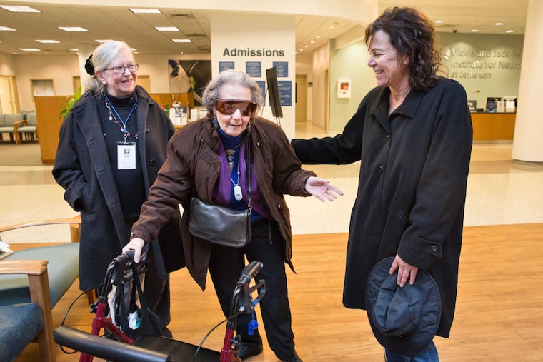 Stella Buccella, a volunteer driver with Penn's Village, a Center City community group, brought Elaine Nettis, center, to her appointment at Jefferson Headache Center. Health pal Marianne Waller, left, met them in the lobby.