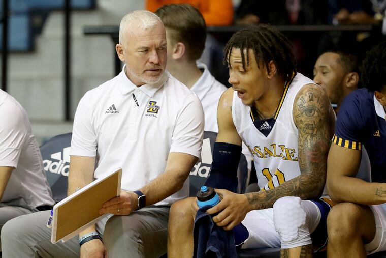 Assistant Coach Pat Chambers, left, of La Salle talks with Josh Nickelberry during their game against and of Fairleigh Dickinson on Dec. 7, 2021.