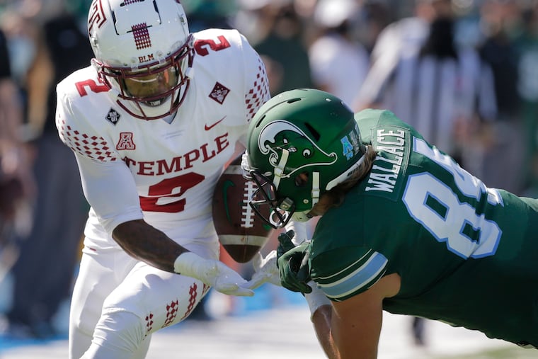 Temple cornerback Christian Braswell intercepts a pass intended for Tulane tight end Will Wallace during the first half in New Orleans.