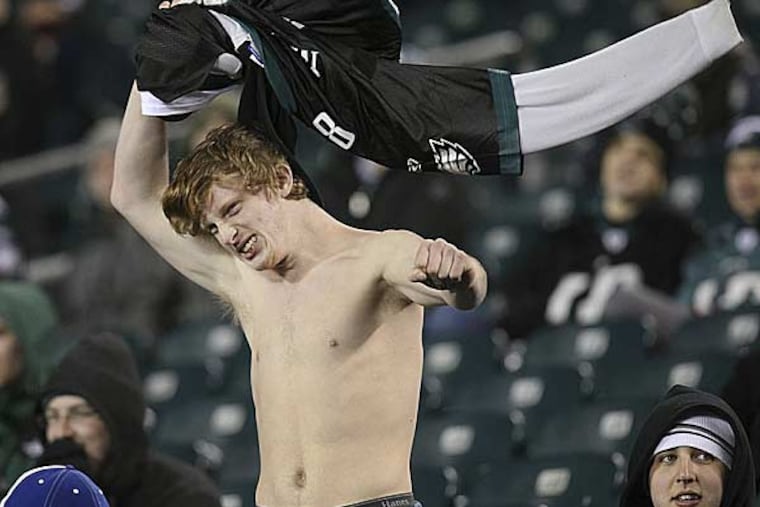 An Eagles fan takes his jersey off as his team loses to the
Bengals at Lincoln Financial Field, Thursday, December 13, 2012. (Steven M. Falk/Staff Photographer)